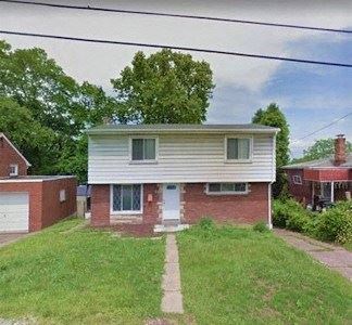 Mckeesport house for rent - a white and brick house on a grassy yard