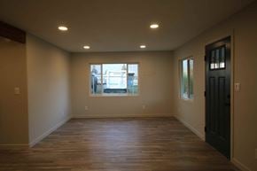 Dallas house for rent - a empty living room with a black door and a window