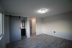 Dallas house for rent - a living room with a wood floor and a door to a bathroom