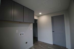 Dallas house for rent - a room with white walls and a door and white cabinets