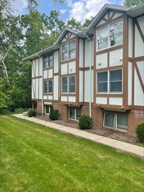 Ann Arbor apartment for rent - a side view of a building with a lawn and grass