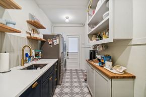 Tampa apartment for rent - A kitchen with a white counter top and black cabinets.