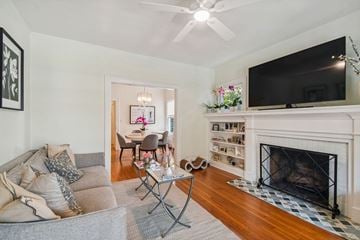 Tampa apartment for rent - A living room with a grey couch and a fireplace.