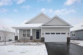 Hastings house for rent - a white house with a garage door in the snow