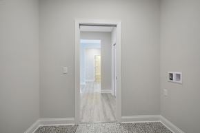 Hastings house for rent - a living room and hallway with white walls and wood floors
