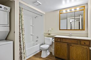 Roselle apartment for rent - A bathroom with a toilet, sink, and mirror.