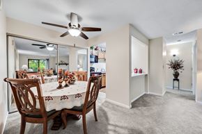 Roselle apartment for rent - A dining room with a table set for six and a ceiling fan.