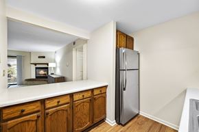 Roselle apartment for rent - A kitchen with wooden cabinets and a stainless steel refrigerator.