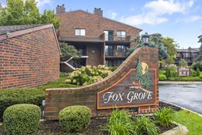 Roselle apartment for rent - A sign for Fox Grove is in front of a building.