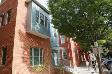 Frederick apartment for rent - a red brick building with a blue building next to it
