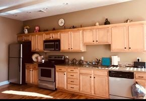 Rome apartment for rent - a kitchen with wooden cabinets and stainless steel appliances