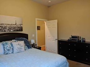 Rome apartment for rent - a bedroom with a bed and a dresser and a painting on the wall