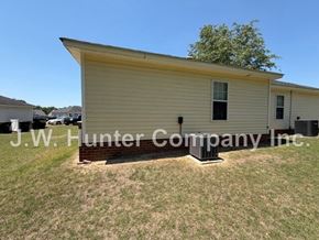 Wilson apartment for rent - A small yellow building with J.W. Hunter Company Inc written on it.