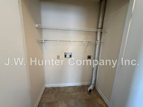 Wilson apartment for rent - A room with a white wall and a white pipe running along it.