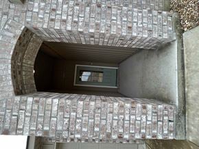 Duson house for rent - a brick archway with a window in a building