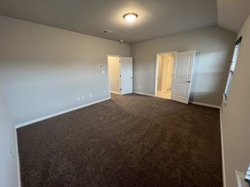 Duson house for rent - a living room with carpet and a door into a bedroom