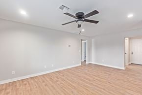 Phoenix apartment for rent - a living room with white walls and a ceiling fan