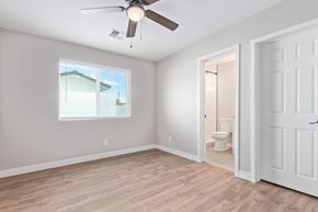 Phoenix apartment for rent - an empty bedroom with a ceiling fan and a bathroom