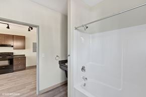 Whitefish apartment for rent - A white bathtub with a shower head attached to the wall.