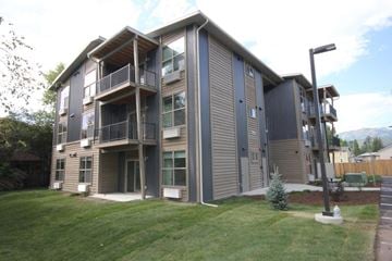 Whitefish apartment for rent - A modern apartment building with a balcony on the second floor.