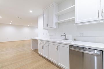 Inglewood apartment for rent - A kitchen with white cabinets and a stainless steel sink.