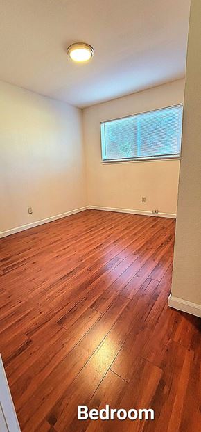 San Jose apartment for rent - a bedroom with a hard wood floor and a window