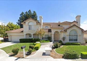 Cupertino house for rent - a house with a driveway and lawn in front of it