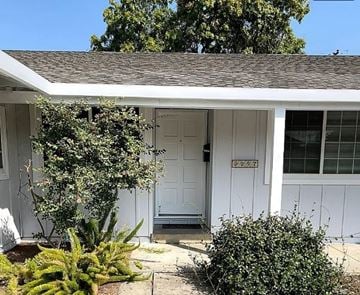 Santa Clara house for rent - a white house with a white door and plants