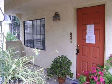 San Jose house for rent - a house with a red door and a sign on the door