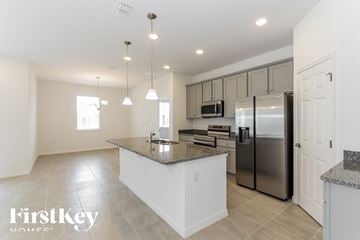 Bartow house for rent - a large kitchen with stainless steel appliances and granite counter tops