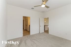 Bartow house for rent - a living room with white walls and a ceiling fan