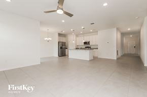 Bartow house for rent - an empty kitchen and living room with a ceiling fan