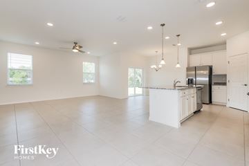 Bartow house for rent - a large kitchen with white cabinets and a white counter top