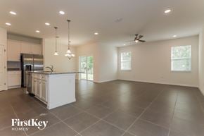 Bartow house for rent - an open kitchen and living room with a large island and stainless steel appliances