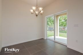 Bartow house for rent - a dining room with a sliding glass door to the backyard