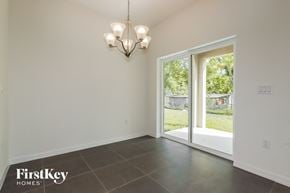 Bartow house for rent - a dining room with a large window and a chandelier