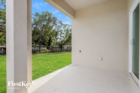 Bartow house for rent - the backyard of a house with grass and a yard