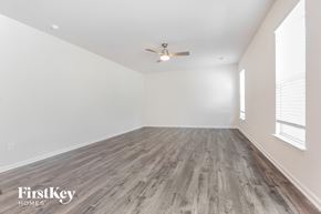 Greenville house for rent - A room with wooden flooring and a ceiling fan.