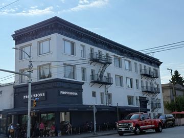 Vancouver apartment for rent - A white building with a black awning that says Provisions.