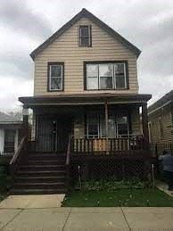 Chicago apartment for rent - a yellow house with a porch and a