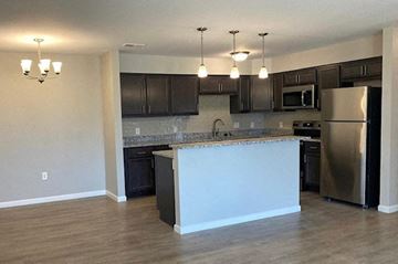 Newburgh apartment for rent - a kitchen with an island and stainless steel refrigerator