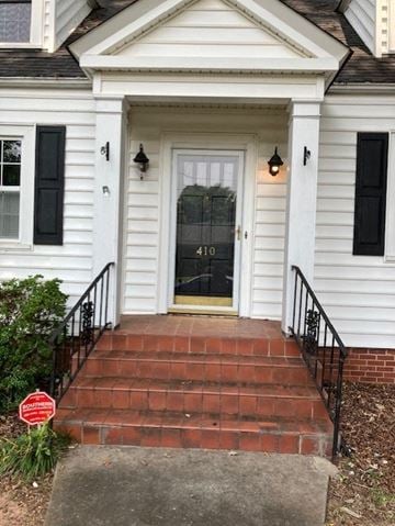 Anderson apartment for rent - the front door of a white house with steps and a porch