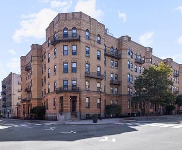 Hoboken apartment for rent - A large red brick building with many windows and balconies.