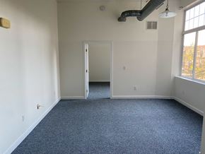 Bridgeport apartment for rent - A room with a carpeted floor and a doorway leading to another room.