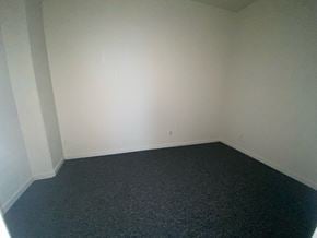 Bridgeport apartment for rent - A room with a black carpet and white walls.