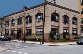 Hoboken apartment for rent - A yellow line is painted on the sidewalk in front of a building.