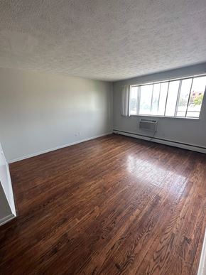 Flint apartment for rent - A room with wooden flooring and a window.