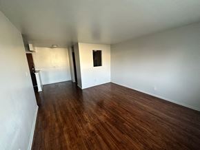 Flint apartment for rent - A room with wooden floors and white walls.