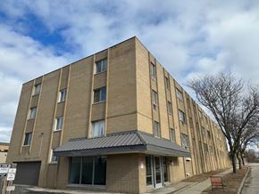 Flint apartment for rent - A large brick building with a black awning and a sign that reads 411.