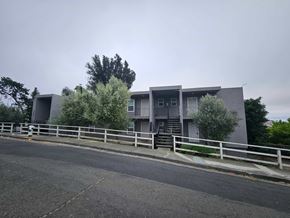 Vallejo apartment for rent - A grey building with a white fence in front of it.